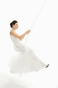 Asian bride swinging in swing set. 