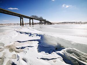 Bridge over frozen water in Midwestern USA.