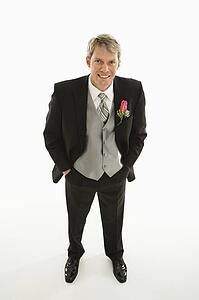 Portrait of Caucasian groom with hands in pockets.