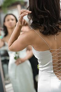 Woman in evening gown looking at mirror