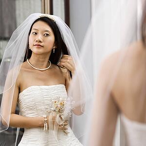 Bride looking at herself in a mirror