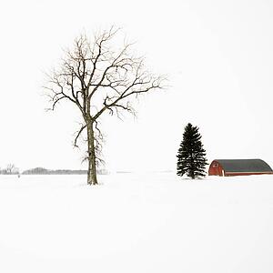 Red barn in snow covered landscape in Midwestern USA
