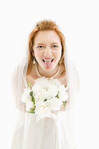 Bride holding bouquet and sticking her tongue out