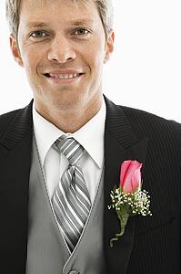 Portrait of Caucasian male in tuxedo with boutonniere.