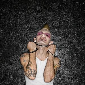 Punk holding handcuffs beneath chin