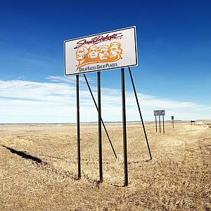 Sign with South Dakota's slogan on side of highway.