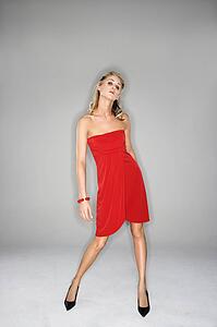 Full length portrait of woman in red dress.