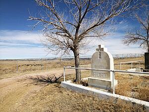 Headstone at the corner of a cemetery.