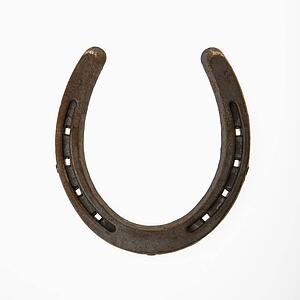 Upside down horseshoe against white background.