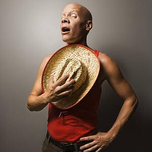 Portrait of a Mid-adult Caucasian male holding stray hat over chest.