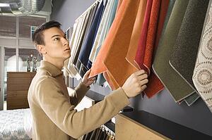 Male looking at fabric swatches in retail store