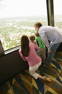 Family looking out observation deck at Tower of the Americas in San Antonio, Texas