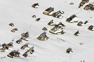 Aerial of snow covered buildings in small town, California, USA.