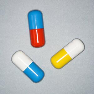 Medical pills on a gray background.