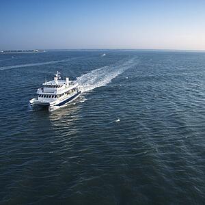 Aerial view of passenger ferry boat in open waters near Bald Head Island, North Carolina.
