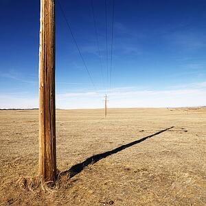 Power line against blue sky.