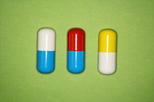 Medical pills on a green background.