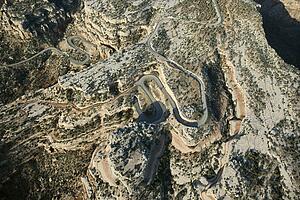 Aerial of curvy road in high desert landscape of Utah, USA.