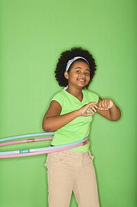 Girl hula hooping and smiling