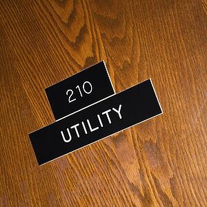 Shot of utility sign on wooden door.