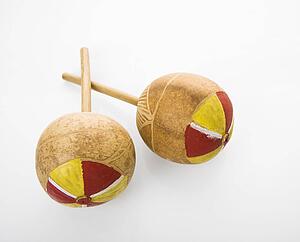 Pair of handmade Mexican maracas percussion musical instruments against white background.