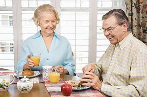 Mature couple having breakfast together