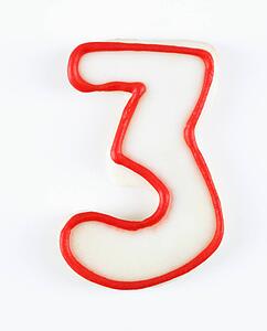 Sugar cookie in the shape of a number three outlined in red icing.