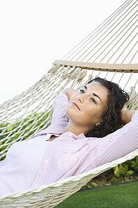Female lying in hammock relaxing