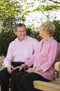 Couple sitting together on bench