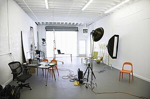 Photography studio with lights and various equipment and props