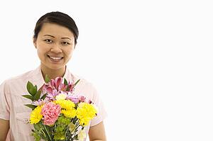 Holding bouquet of flowers