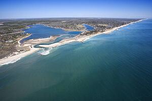 Aerial view of Southampton, New York with shoal and inlet.