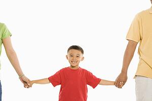 Parents holding hands with son