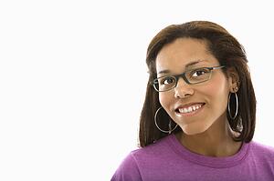 African American mid adult woman wearing glasses smiling at viewer.