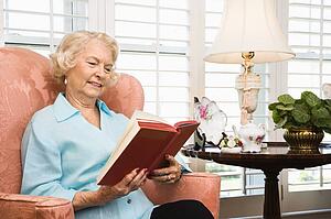 Woman sitting in chair reading a book
