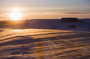 Ice covered road and snowy rural landscape