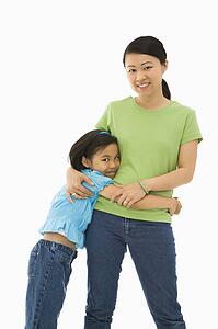 Mother and daughter standing with arms around each other