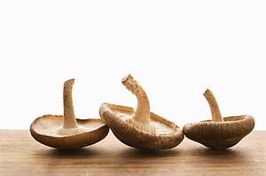 Three brown mushrooms upside down.