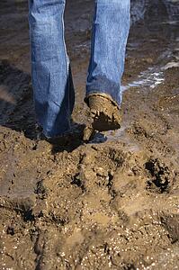 Walking in mud wearing jeans and boots