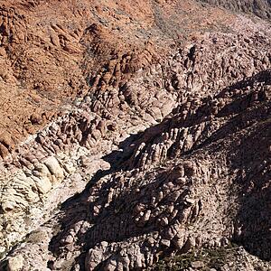 Aerial view of red rock cliffs in southwest
