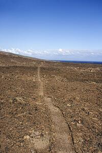 Pathway leading through rocky terrain in Maui, Hawaii