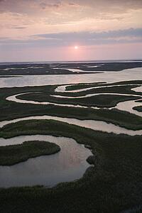 Aerial scenic Bald Head Island North Carolina landscape of marshland during sunrise.