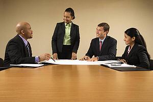 Businesspeople having meeting at conference table