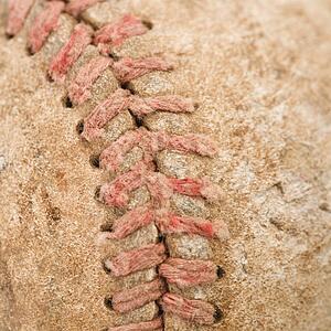 Detail of stitching on dirty worn baseball.
