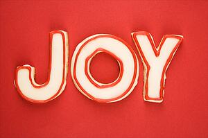 Sugar cookies with decorative icing that spell joy.