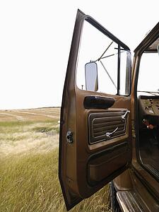 Farm truck with driver side door open.