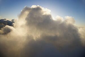Skyscape with big cloud and blue sky.