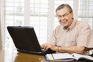 Man typing on laptop in home