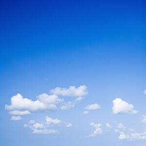 Blue sky with some white puffy clouds.