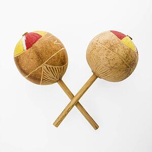 Pair of handmade Mexican maracas percussion musical instruments against white background.